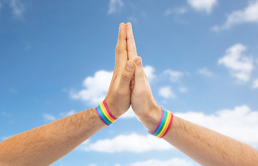 Image showing hands with gay pride wristbands make high five