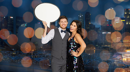 Image showing happy couple at party holding text bubble banner