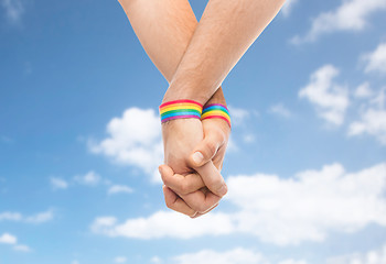 Image showing hands of couple with gay pride rainbow wristbands