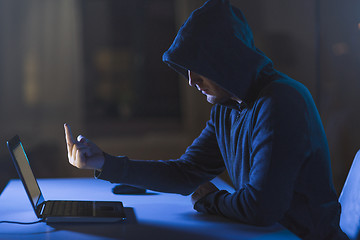 Image showing hacker showing middle finger to laptop