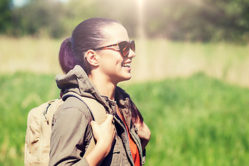 Image showing happy young woman with backpack hiking outdoors