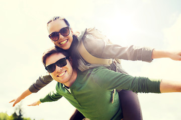 Image showing happy couple with backpacks having fun outdoors