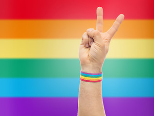 Image showing hand with gay pride rainbow wristband make peace