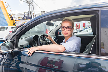 Image showing Female driver parking her car on ferry boat on trip to their summer vacations island destination. Sardinia, Italy