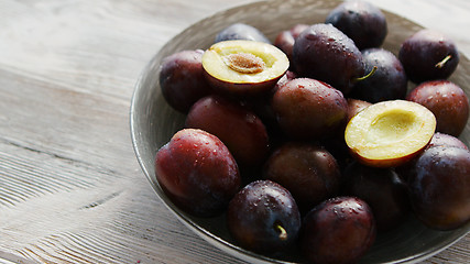 Image showing Bowl of fresh plums in daylight