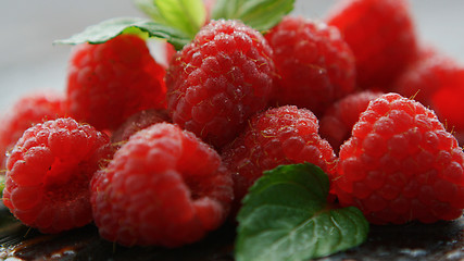 Image showing Ripe appetizing raspberry with leaves 
