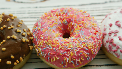 Image showing Glazed sweet doughnuts in closeup