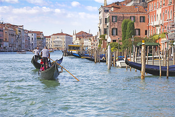 Image showing Venetian gondolier in the gondola is transported tourists throug