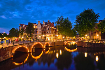 Image showing Amterdam canal, bridge and medieval houses in the evening