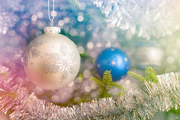 Image showing Christmas-tree decoration bauble on decorated Christmas tree bac