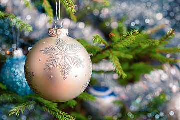 Image showing Christmas-tree decoration bauble on decorated Christmas tree bac