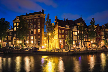 Image showing Amterdam canal, bridge and medieval houses in the evening