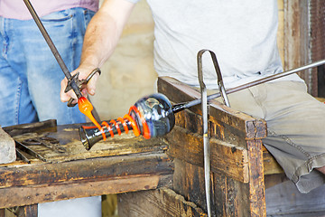 Image showing Glass worker makes glass sculptures in glass factory in Murano, 