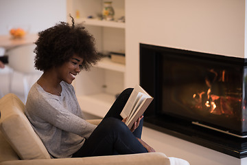 Image showing black woman at home reading book