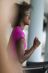 Image showing afro american woman running on a treadmill