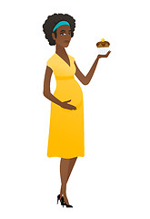 Image showing Pregnant woman holding a cupcake.