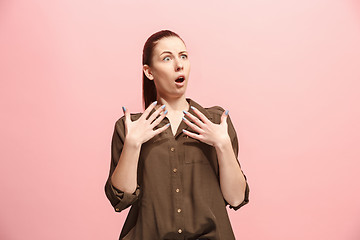 Image showing Beautiful woman looking suprised isolated on pink