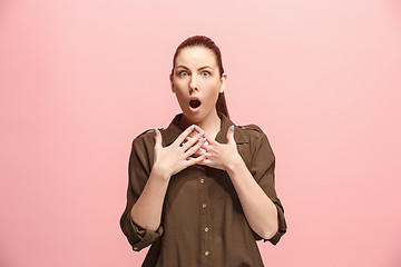 Image showing Beautiful woman looking suprised isolated on pink