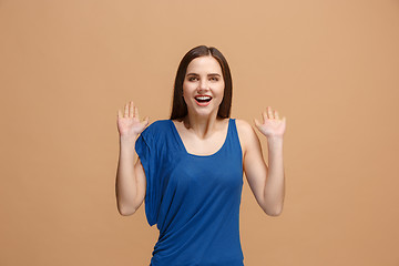 Image showing The happy business woman standing and smiling against pastel background.