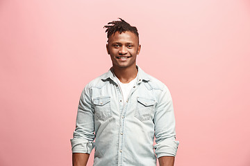 Image showing The happy business man standing and smiling against pink background.