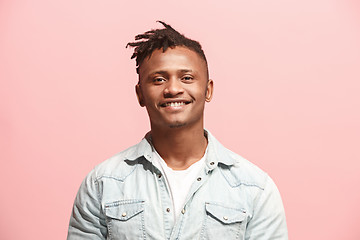 Image showing The happy business man standing and smiling against pink background.