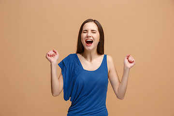 Image showing The happy business woman standing and smiling against pastel background.