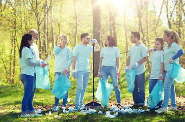 Image showing group of volunteers with garbage bags in park