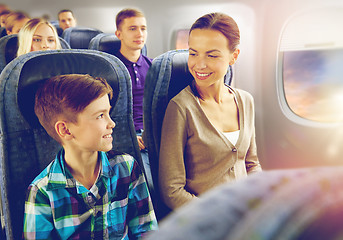 Image showing happy mother and son traveling by plane