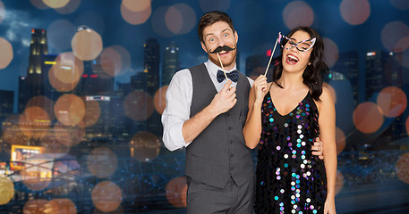 Image showing happy couple with party props having fun