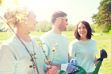 Image showing group of volunteers with tree seedlings in park