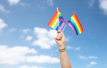 Image showing hand with gay pride rainbow flags and wristband