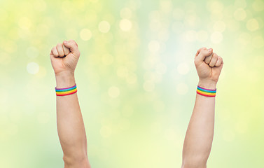 Image showing hands with gay pride rainbow wristbands shows fist