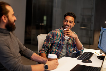 Image showing creative team drinking coffee at night office