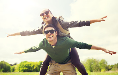 Image showing happy couple with backpacks having fun outdoors