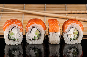 Image showing Several Philadelphia Sushi roll in a row