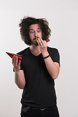 Image showing Portrait of a man in party hat blowing in whistle