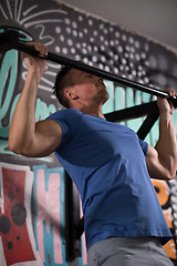 Image showing man doing pull ups