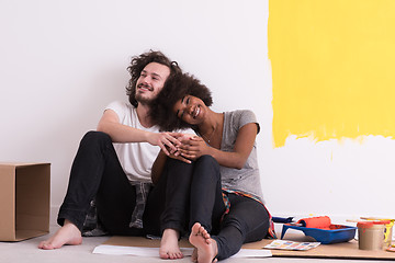 Image showing young multiethnic couple relaxing after painting