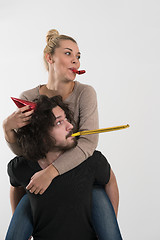 Image showing couple in party hats blowing in whistle