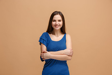 Image showing The happy business woman standing and smiling against pastel background.