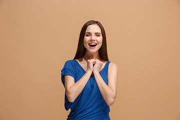 Image showing The happy business woman standing and smiling against pastel background.