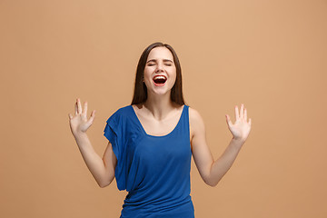 Image showing The happy business woman standing and smiling against pastel background.