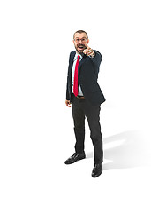 Image showing Full body portrait of happy businessman pointing to camera on white