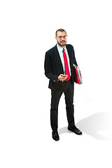 Image showing Happy businessman talking on the phone with folder in hand isolated over white background in studio shooting