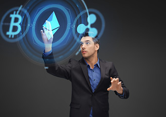 Image showing businessman with cryptocurrency holograms