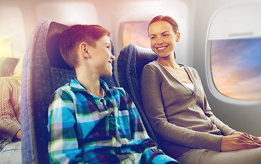 Image showing happy mother and son traveling by plane