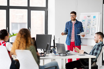 Image showing creative man showing user interface at office