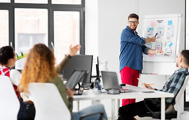 Image showing creative man showing user interface at office