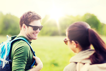 Image showing smiling couple with backpacks in nature