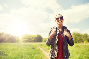 Image showing happy young woman with backpack hiking outdoors